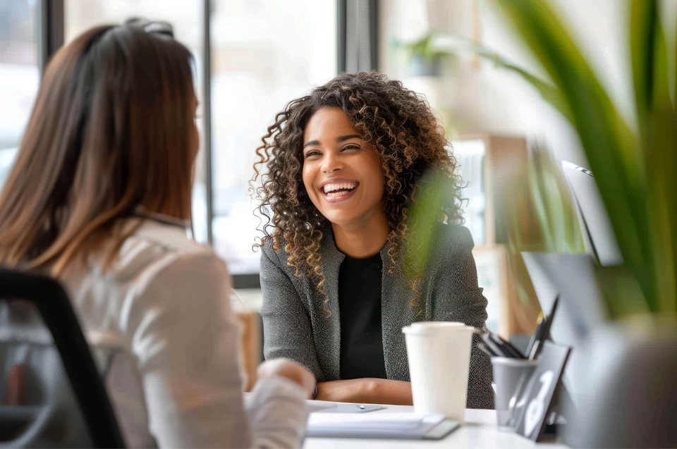 Recruitment consultant interviewing a smiling candidate